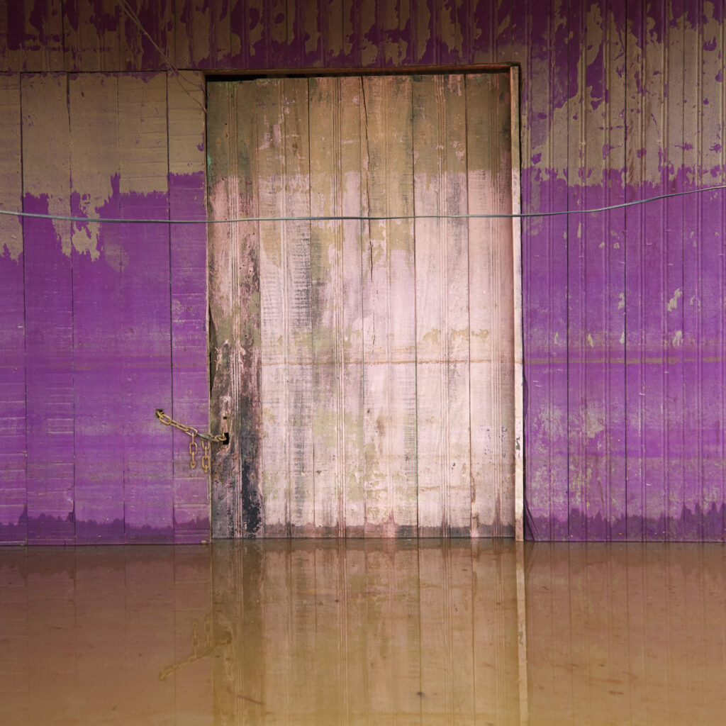 From the "Floodlines" series: Mendel registers the mark left by the increase in the water level at the entrance to a house in the district of Taquari. Rio Branco, Brazil, March 2015.